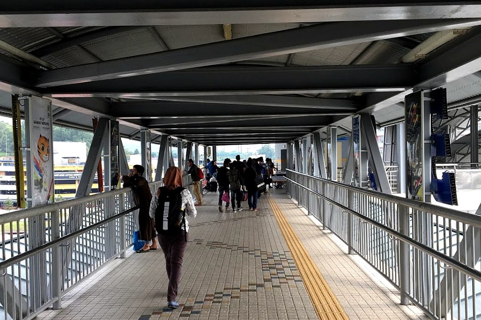 Passengers walking on the pedestrian bridge