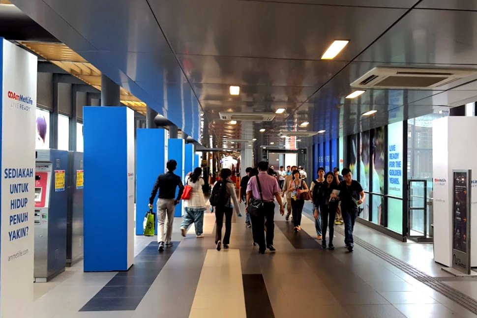 Commuters walking toward the station from Nu Sentral