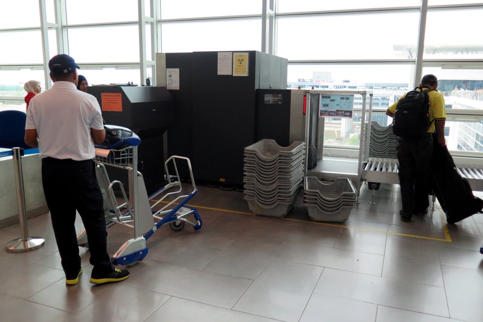 Passengers loading the oversize baggage at the Departure Hall