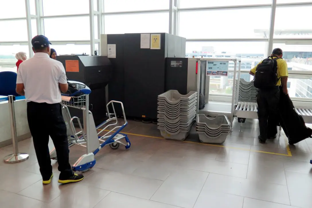 Passengers loading the oversize baggage at the Departure Hall