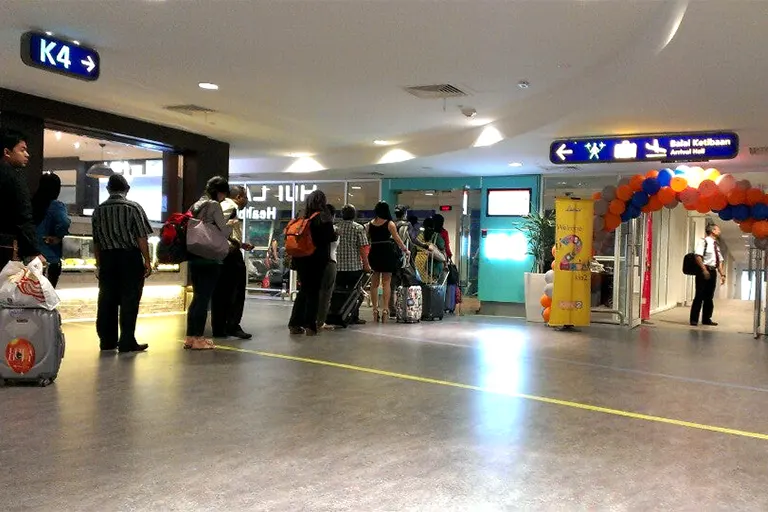 Travelers entering the waiting area